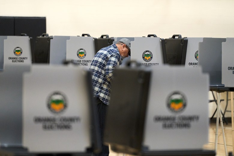 A voter at a polling center at Santa Ana College in Santa Ana on March 5, 2024. Photo by Lauren Justice for CalMatters