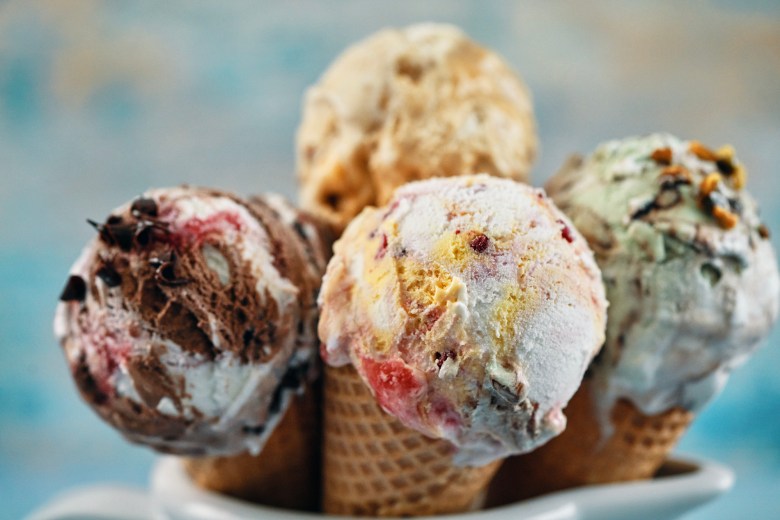 Four colorful ice cream cones in a bowl.