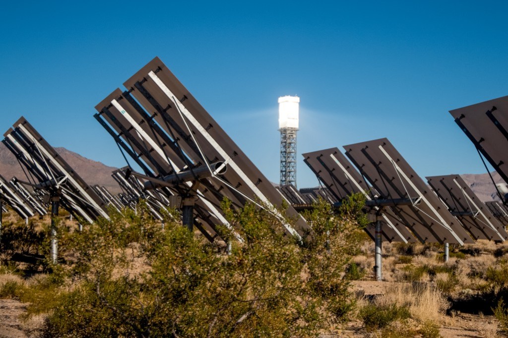 Solar panels face the sun in the Mojave desert on a clear sky day.