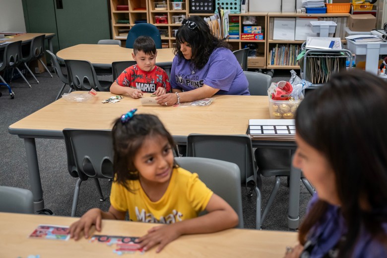 Teachers Michelle Ramos-La Grone and Elsa Cintora work with students in the transitional kindergarten program at Westwood Elementary School in Stockton on Sept. 22, 2023. Photo by Loren Elliott for CalMatters