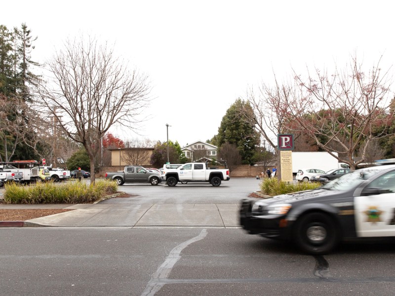 A police car passes by the parking lot between Mercy Street and California Street in downtown Mountain View on Jan. 16, 2019. The city is kicking off a project to make travel on California Street safer in 2024. Photo by Magali Gauthier