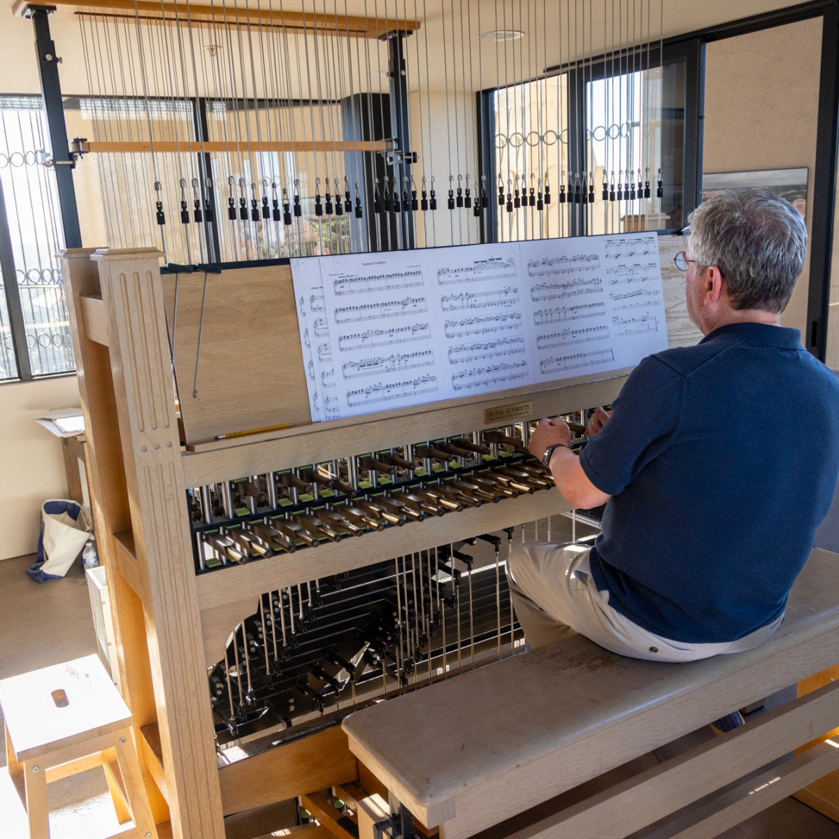 Musician always hits a high note, playing the tower bells above Stanford